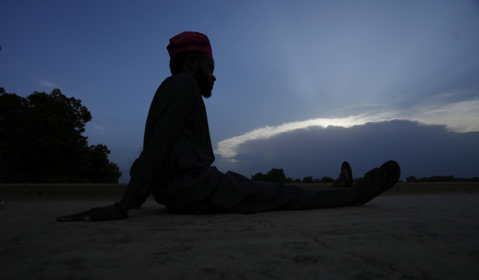 An atheist sits and looks over the river Yobe in Gashua Nigeria Tuesday, July 11, 2023. Nonbelievers in Nigeria said they perennially have been treated as second-class citizens in the deeply religious country whose 210 million population is almost evenly divided between Christians dominant in the south and Muslims who are the majority in the north. Some nonbelievers say threats and attacks have worsened in the north since the leader of the Humanist Association of Nigeria, Mubarak Bala, was arrested and later jailed for blasphemy. (AP Photo/Sunday Alamba)