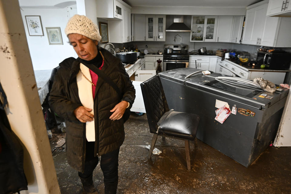 Homeowner Maria Ramirez walks through her flood damaged home Tuesday, Jan. 23, 2024, in San Diego. (AP Photo/Denis Poroy)