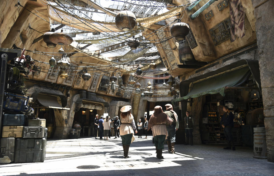 Characters stroll through the marketplace at the Black Spire Outpost during the Star Wars: Galaxy's Edge Media Preview at Disneyland Park, Wednesday, May 29, 2019, in Anaheim, Calif. (Photo by Chris Pizzello/Invision/AP)