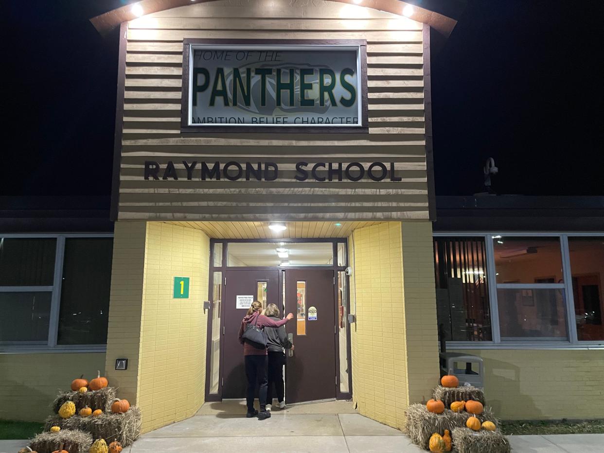 Residents file into Raymond School Nov. 20, 2023, for a school board meeting.