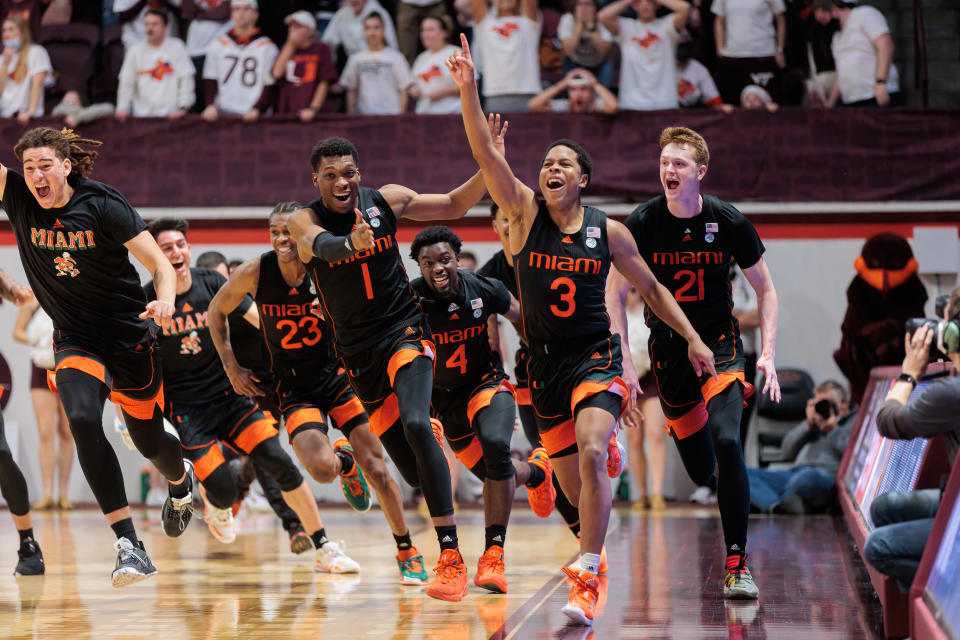 Jan 26, 2022; Blacksburg, Virginia, USA; Miami Hurricanes players celebrate after Charlie Moore’s (3) buzzer beater against Virginia Tech Hokies during the second half at Cassell Coliseum. Mandatory Credit: Ryan Hunt-USA TODAY Sports