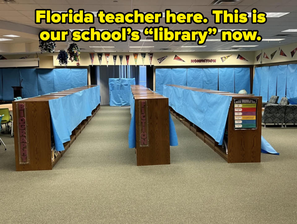 Library shelves covered with blue sheets, labeled "Biography" and "Fiction", with a colorful reading chart on the right. Banners hang from the ceiling