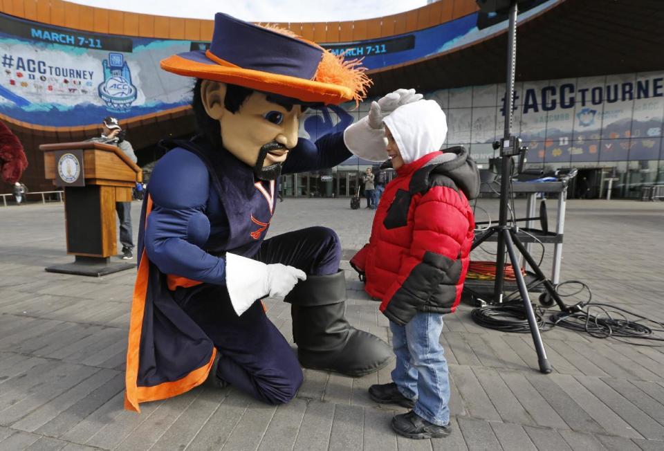 The Virginia Cavaliers' mascot pauses to greet three year-old Justice Calderon, Monday, March 6, 2017, outside the Barclays Center in New York. All 15 of the Atlantic Coast Conference mascots were on hand Monday to promote the ACC basketball tournament which will be played March 7-11 at the Barclays Center in Brooklyn. (AP Photo/Kathy Willens)