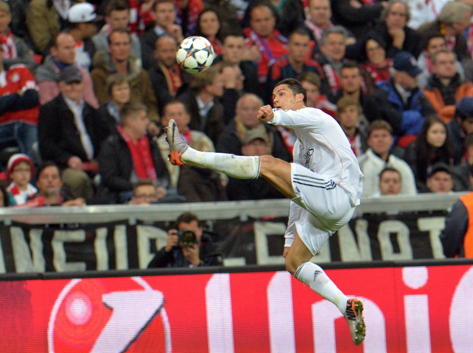 Real's Cristiano Ronaldo jumps for the ball during the Champions League semifinal second leg soccer match between Bayern Munich and Real Madrid at the Allianz Arena in Munich, southern Germany, Tuesday, April 29, 2014. (AP Photo/Kerstin Joensson)