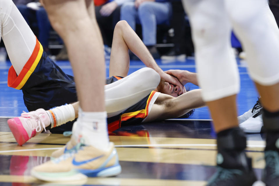 Nov 3, 2023; Oklahoma City, Oklahoma, USA; Oklahoma City Thunder forward Chet Holmgren (7) lays on the court after getting hit in the face by Golden State Warriors forward Draymond Green during the second half at Paycom Center. Mandatory Credit: Alonzo Adams-USA TODAY Sports