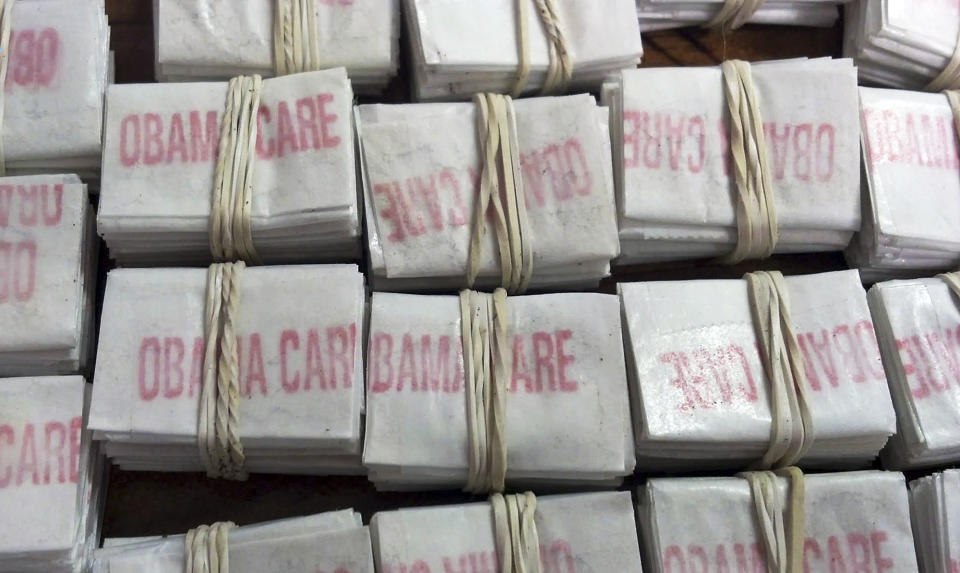 FILE - This photo released on Friday, Dec. 20, 2013 by the Massachusetts State Police shows some of the 1,250 packets of heroin labeled "Obamacare" and "Kurt Cobain" which state police troopers confiscated during a traffic stop in Hatfield, Mass. Four people were charged with heroin trafficking. (AP Photo/Massachusetts State Police)