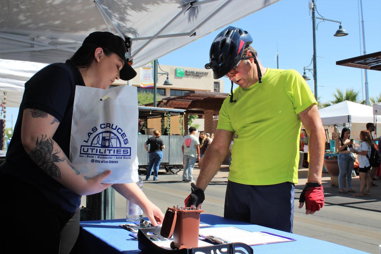 Las Cruces Utilities Administrative Assistant Allison MacGillivray explains answers to a survey taker at the Farmer’s Market.
