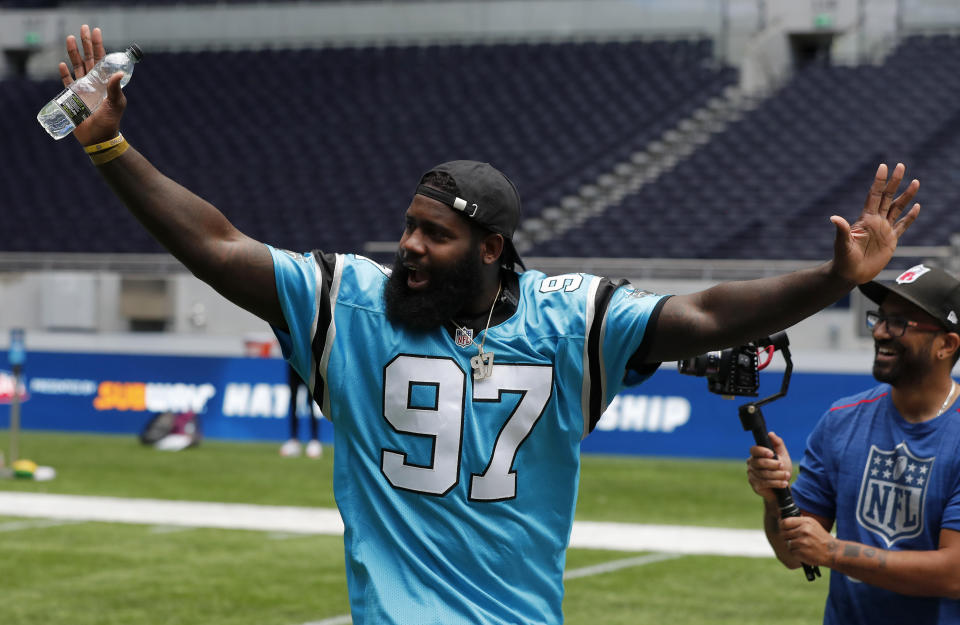 NFL player Mario Addison of the Carolina Panthers complains to the referee as he coaches a young team during the final tournament for the UK's NFL Flag Championship, featuring qualifying teams from around the country, at the Tottenham Hotspur Stadium in London, Wednesday, July 3, 2019. The new stadium will host its first two NFL London Games later this year when the Chicago Bears face the Oakland Raiders and the Carolina Panthers take on the Tampa Bay Buccaneers. (AP Photo/Frank Augstein)