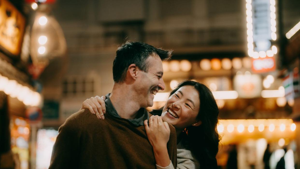 couple having fun in tokyo at night