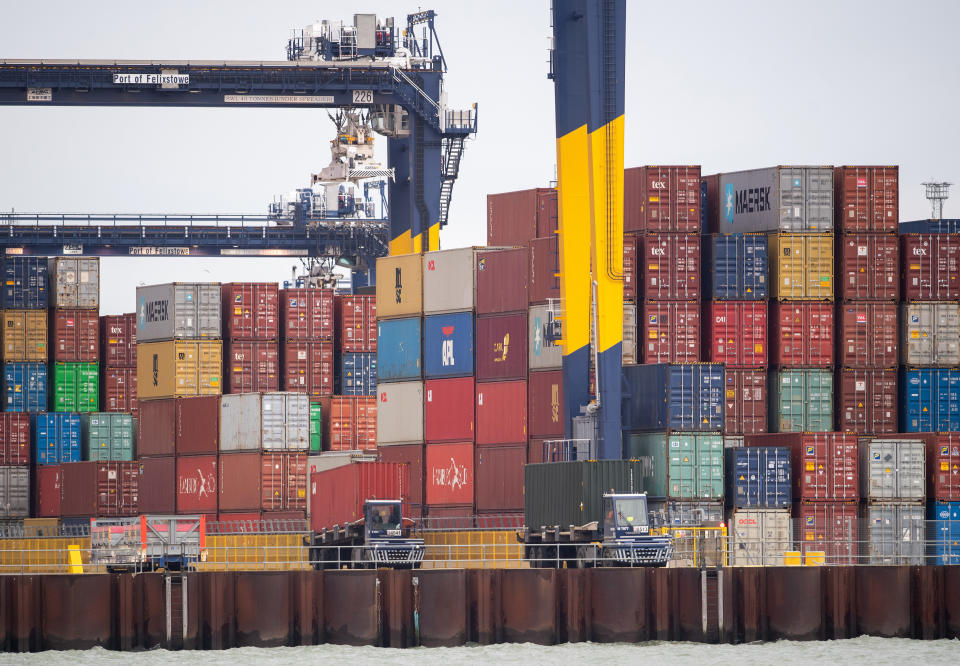 Shipping containers are unloaded from a cargo ship at the Port of Felixstowe in Suffolk. Shipments of personal protective equipment have been clogging UK ports, causing huge delays compounded by retailers and manufacturers importing goods for the Christmas shopping rush. (Photo by Joe Giddens/PA Images via Getty Images)