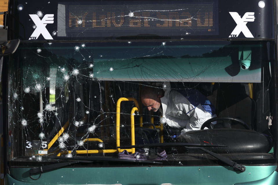 Israeli police inspect the scene of an explosion at a bus stop in Jerusalem, Wednesday, Nov. 23, 2022. Two blasts went off near bus stops in Jerusalem on Wednesday, injuring several people in what police said were suspected attacks by Palestinians. (Ohad Zwigenberg/HAARETZ via AP)