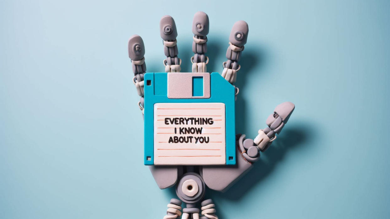  Claymation robot hand holding a floppy disk that reads "Everything I know about you.". 