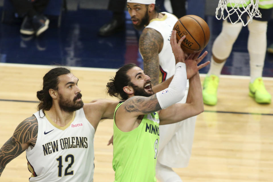 Minnesota Timberwolves guard Ricky Rubio (9) shoots against New Orleans Pelicans center Steven Adams (12) in the first quarter during an NBA basketball game, Saturday, Jan. 23, 2021, in Minneapolis. (AP Photo/Andy Clayton-King)