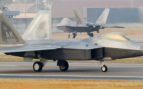 US Air Force F-22 Raptor stealth jets are seen at a South Korean air base in Gwangju on December 4 - Credit: AFP