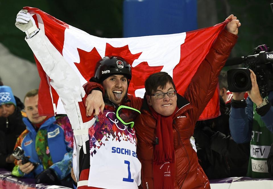 Winner Canada's Alex Bilodeau (L) and his brother Frederic celebrate after the men's freestyle skiing moguls finals at the 2014 Sochi Winter Olympic Games in Rosa Khutor, February 10, 2014. REUTERS/Dylan Martinez