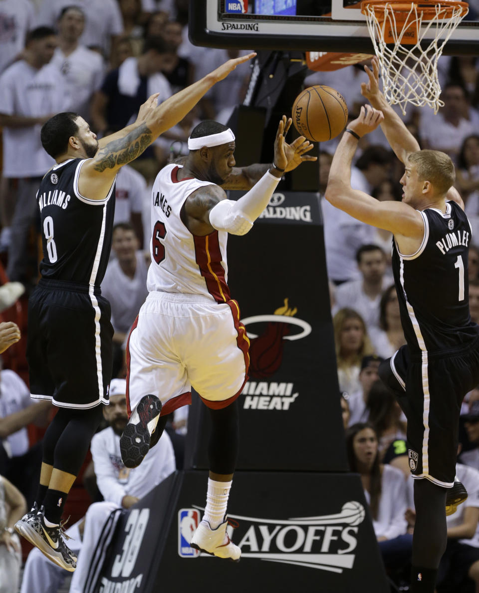 Brooklyn Nets' Deron Williams (8) and Mason Plumlee (1) pressure Miami Heat's LeBron James (6) in the second half of Game 1 in an NBA basketball Eastern Conference semifinal playoff series, Tuesday, May 6, 2014, in Miami. The Heat defeated the Nets 107-86. (AP Photo/Lynne Sladky)