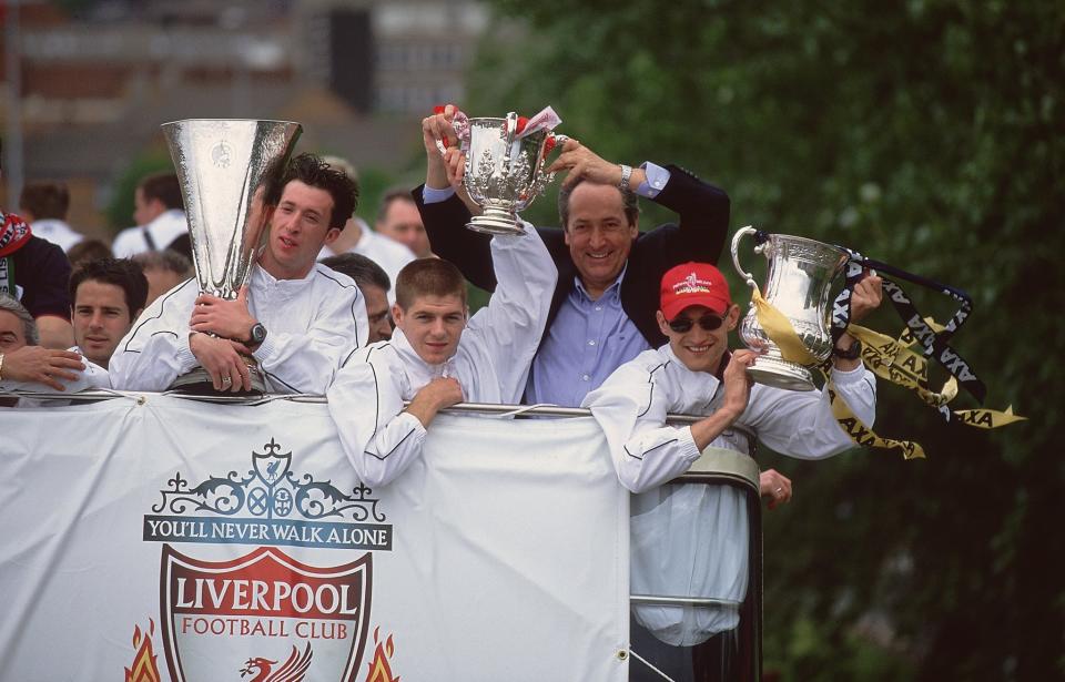 Robbie Fowler, Steven Gerrard, manager Gerard Houllier and Sami Hyypia display Liverpool's three trophies, the UEFA Cup, Worthington Cup and FA Cup in 2001