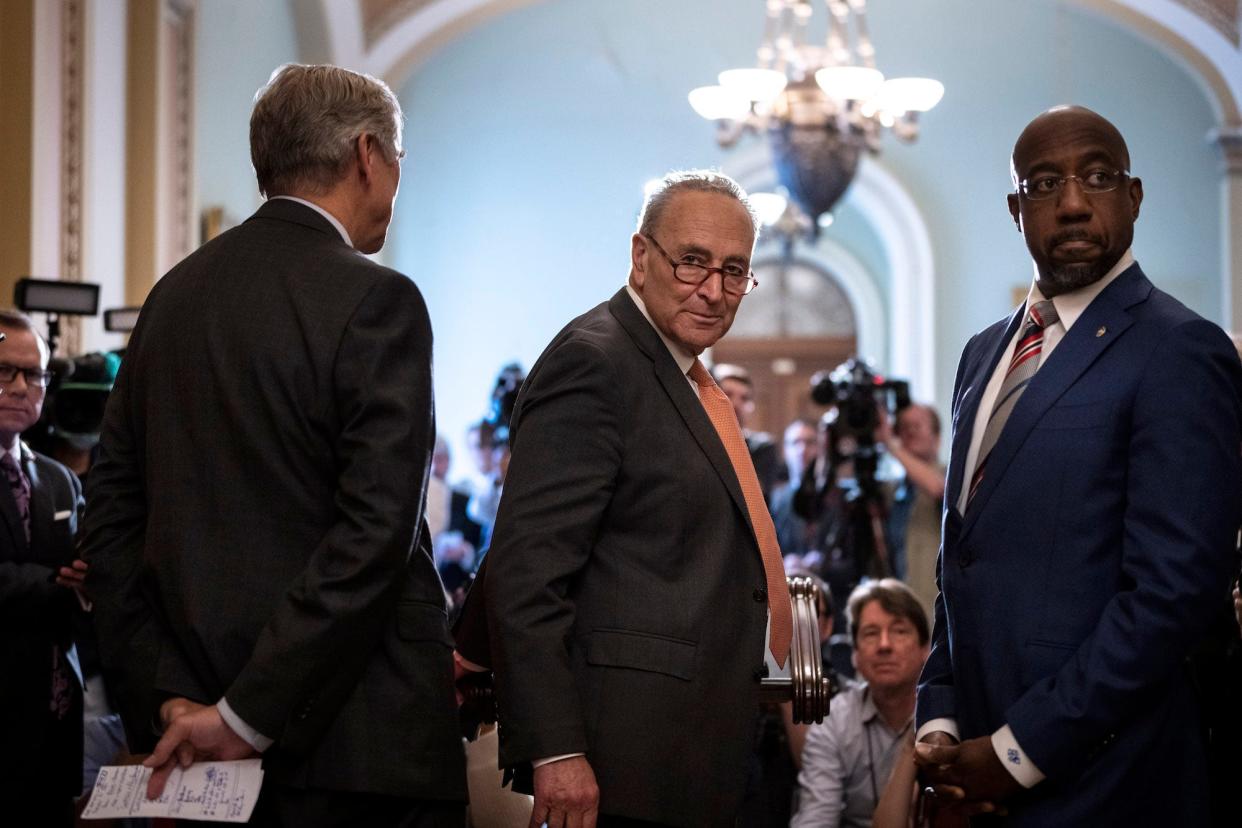 Senate Majority Leader Chuck Schumer and Democratic Sen. Raphael Warnock of Georgia speak to reporters after a policy luncheon with Senate Democrats at the US Capitol on June 22, 2021 in Washington, DC.