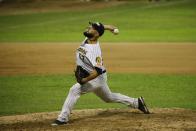 Leones de Caracas' pitcher Carlos Quevedo throws to Tigres of Aragua during the opening winter league baseball game in Caracas, Venezuela, Tuesday, Nov. 5, 2019. The Winter League is one that many major league players use to hone their skills in the offseason, and baseball is part of Venezuela’s national fabric. (AP Photo/Ariana Cubillos)