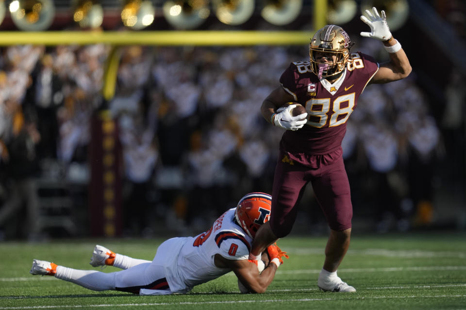 Minnesota tight end Brevyn Spann-Ford (88) runs with the football as defensive back Nicario Harper (0) attempts a tackle during the first half of an NCAA college football game Saturday, Nov. 4, 2023, in Minneapolis. (AP Photo/Abbie Parr)