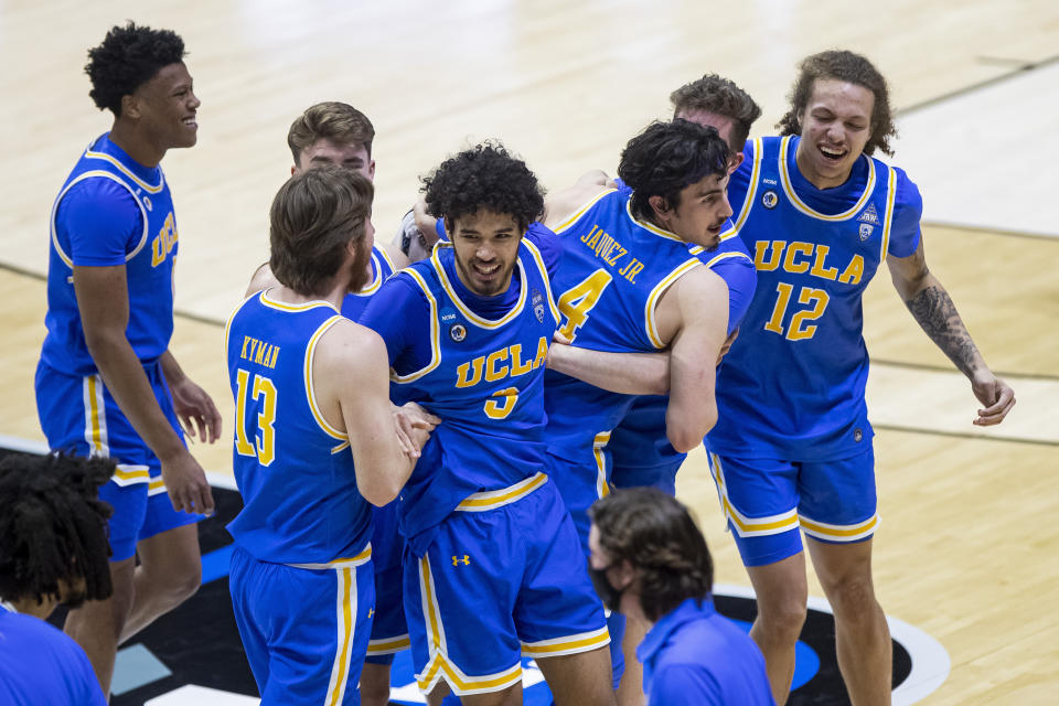 UCLA players celebrate following an 86-80 win over Michigan State in a First Four game in the NCAA men's college basketball tournament, early Friday, March 19, 2021, at Mackey Arena in West Lafayette, Ind. (AP Photo/Robert Franklin)