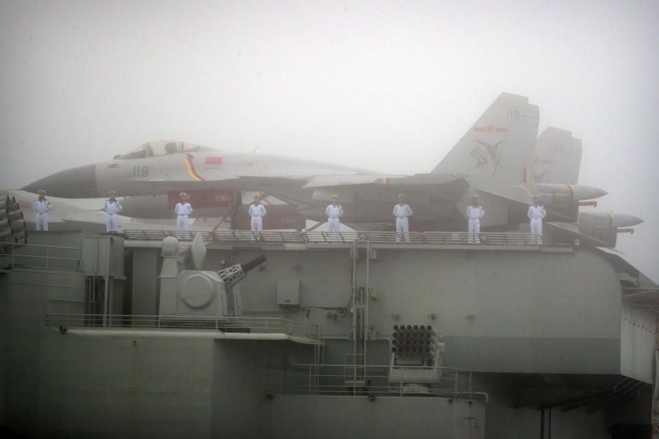 FILE - In this April 23, 2019, file photo, sailors stand near fighter jets on the deck of the Chinese People's Liberation Army (PLA) Navy aircraft carrier Liaoning as it participates in a naval parade in the sea near Qingdao in eastern China's Shandong province. China says its first entirely homebuilt aircraft carrier, yet to be named, has transited the Taiwan Strait on its way to the South China Sea for exercises. (AP Photo/Mark Schiefelbein, Pool)