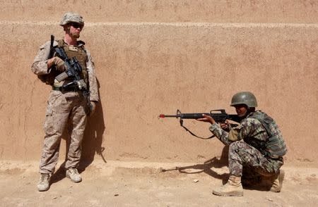 A U.S. Marine stands next to an Afghan National Army (ANA) soldier during a training in Helmand province, Afghanistan, July 5, 2017.REUTERS/Omar Sobhani