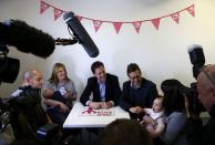 Britain's Liberal Democrat party leader and Deputy Prime Minister Nick Clegg (C) speaks with Amy McGagh (R) and her daughter Sophie during a visit to Millie's Trust in Manchester, northern England, April 2, 2015. REUTERS/Darren Staples