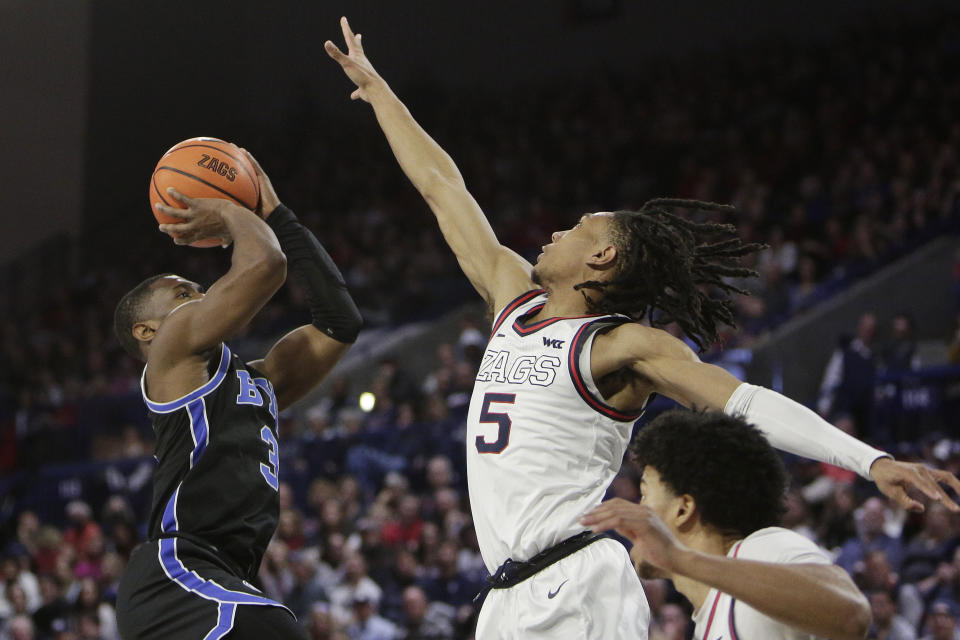 BYU guard Rudi Williams (3) shoots while defended by Gonzaga guard Hunter Sallis (5) during the second half of an NCAA college basketball game Saturday, Feb. 11, 2023, in Spokane, Wash. Gonzaga won 88-81. (AP Photo/Young Kwak)