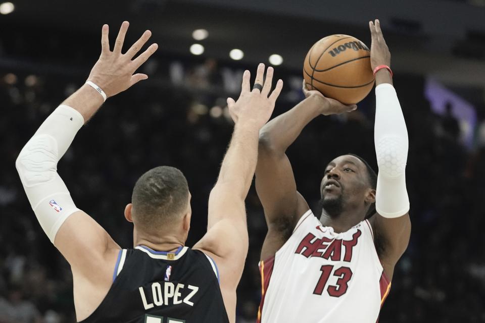 Miami Heat's Bam Adebayo shoots in front on Milwaukee Bucks' Brook Lopez during the first half in Game 1 of an NBA basketball first-round playoff game Sunday, April 16, 2023, in Milwaukee. (AP Photo/Morry Gash)