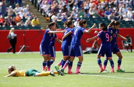 Jun 27, 2015; Edmonton, Alberta, CAN; Japan celebrates the goal by forward Mana Iwabuchi (16) as Australia defender Elise Kellond-Knight (8) reacts during the second half in the quarterfinals of the FIFA 2015 Women's World Cup at Commonwealth Stadium. Japan won 1-0. Mandatory Credit: Erich Schlegel-USA TODAY Sports