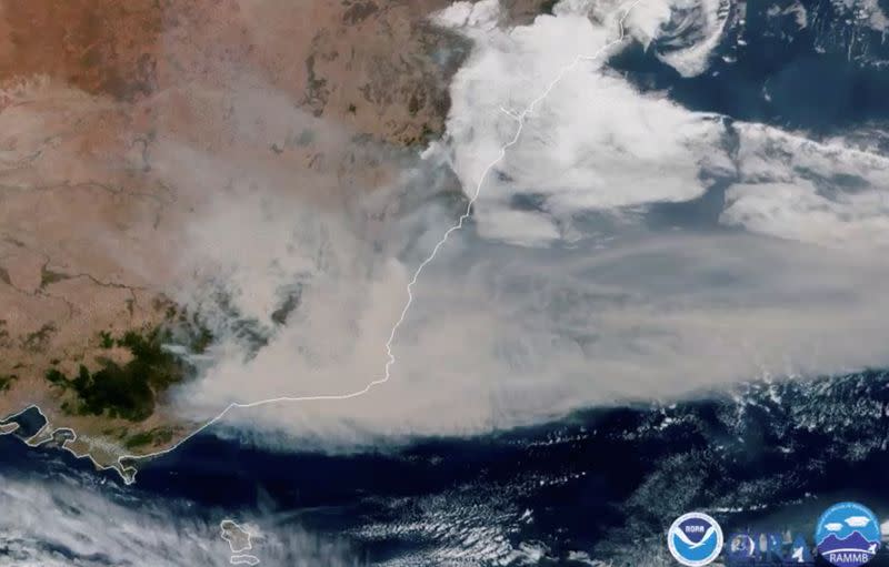 A satellite image shows bushfire smoke being blown away from Australia