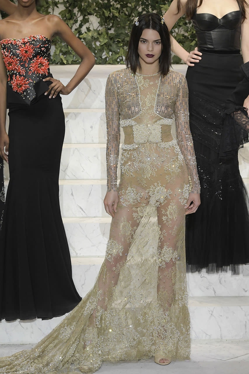 <p>Kendall Jenner leads the way in this La Perla gown in metallic gold lace with intricate embroidery. (Photo: Getty Images) </p>