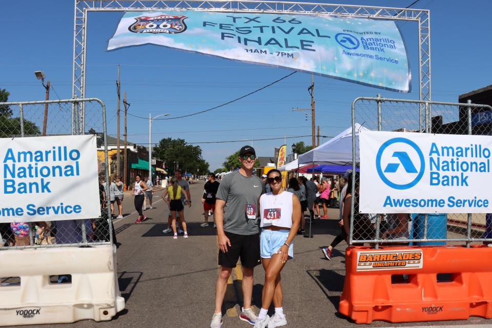 Tanner Urlacher and Rici Galdean get a photo taken before the Fitness @ KT Black 5K/1K Run/Walk on Saturday morning in Amarillo.