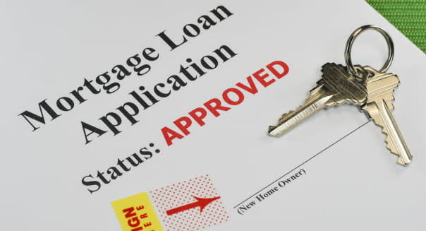 Approved Real Estate Mortgage Loan Document Ready For Signature With House Keys