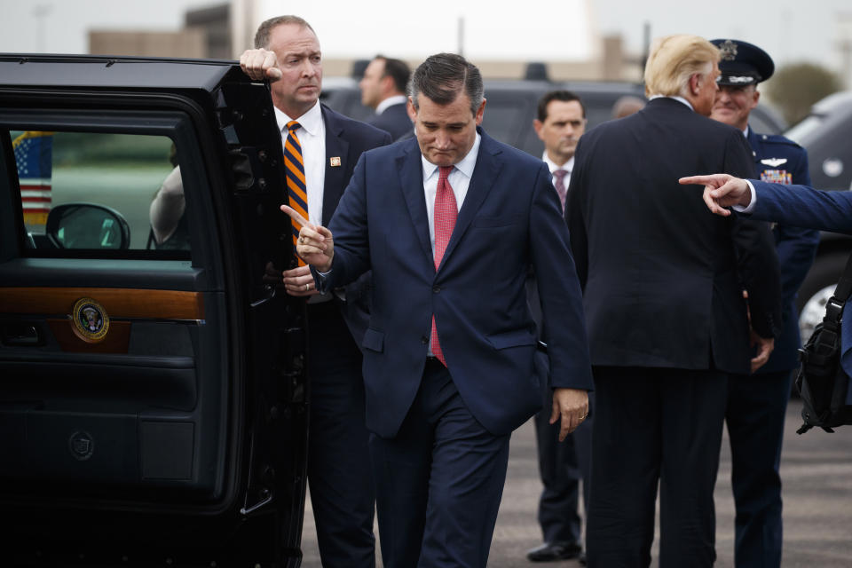 Sen. Ted Cruz, R-Texas, is directed toward the vehicle of President Donald Trump after he arrived at Ellington Field Joint Reserve Base to attend a campaign rally, Monday, Oct. 22, 2018, in Houston. (AP Photo/Evan Vucci)