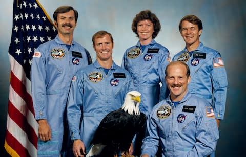 Astronauts who joined the space shuttle Discovery with the eagle, the mission's mascot - Credit: NASA/JSC