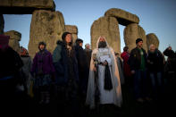 A druid watches the sunrise by the ancient stone circle of Stonehenge, in southern England, as access to the site is given to druids, New Age followers and members of the public on the annual Winter Solstice, Friday, Dec. 21, 2012. Doomsday hour is here and so still are we. According to legend, the ancient Mayans' long-count calendar ends at midnight Thursday, ushering in the end of the world. Didn't happen. "This is not the end of the world. This is the beginning of the new world," Star Johnsen-Moser, an American seer, said at a gathering of hundreds of spiritualists at a convention center in the Yucatan city of Merida, an hour and a half from the Mayan ruins at Chichen Itza. (AP Photo/Matt Dunham)