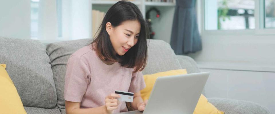 Asian woman using laptop and credit card shopping ecommerce,