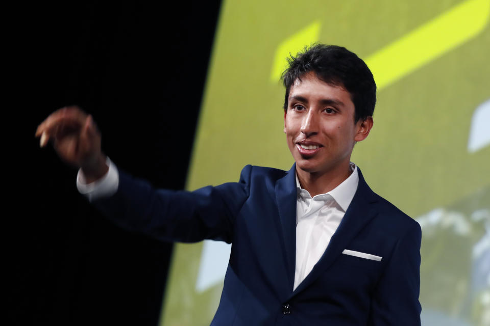 Colombia's Egan Bernal waves to the public during the presentation of the Tour de France 2020 cycling race, in Paris, Tuesday Oct. 15, 2019. The 107th edition of the race starts on June 27 2019 to end on the Champs-Elysees avenue on July 19. (AP Photo/Thibault Camus)