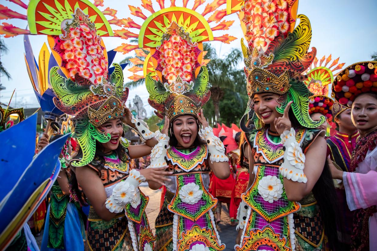 Balinese dancers perform as they take part in a cultural parade, during a new year's eve celebration at a main road in Denpasar, Bali (EPA)