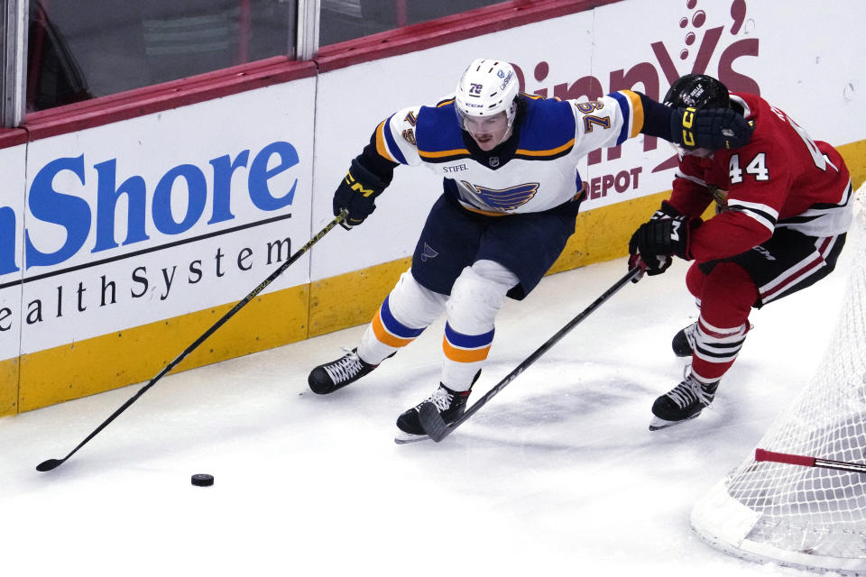 St. Louis Blues left wing Sammy Blais, left, controls the puck against Chicago Blackhawks defenseman Wyatt Kaiser during the second period of an NHL hockey game in Chicago, Sunday, Nov. 26, 2023. (AP Photo/Nam Y. Huh)