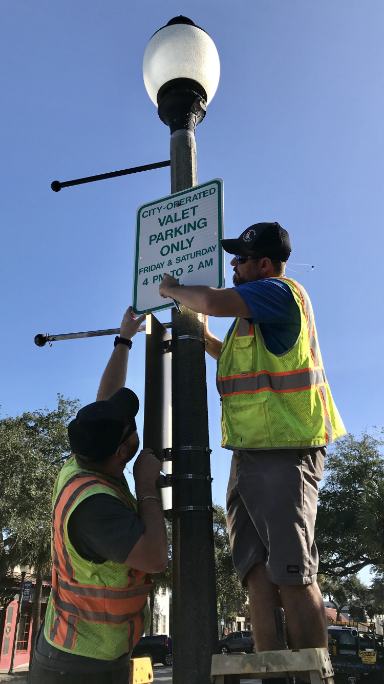 Melbourne traffic engineering workers install a new valet parking sign in January 2020 in front of Matt's Casbah on New Haven Avenue.