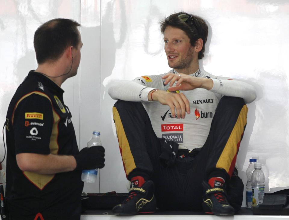 Lotus F1 Formula One driver Romain Grosjean of France (R) attends the first practice session of the Indian F1 Grand Prix at the Buddh International Circuit in Greater Noida, on the outskirts of New Delhi, October 25, 2013. REUTERS/Adnan Abidi (INDIA - Tags: SPORT MOTORSPORT F1)