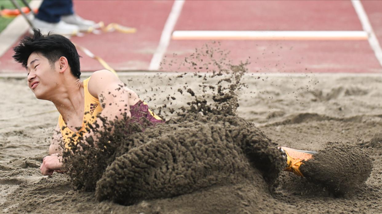 Bloomington North’s Evan Cheng competes in the long jump during the track meet against Bloomington South at North on Wednesday, May 1, 2024.