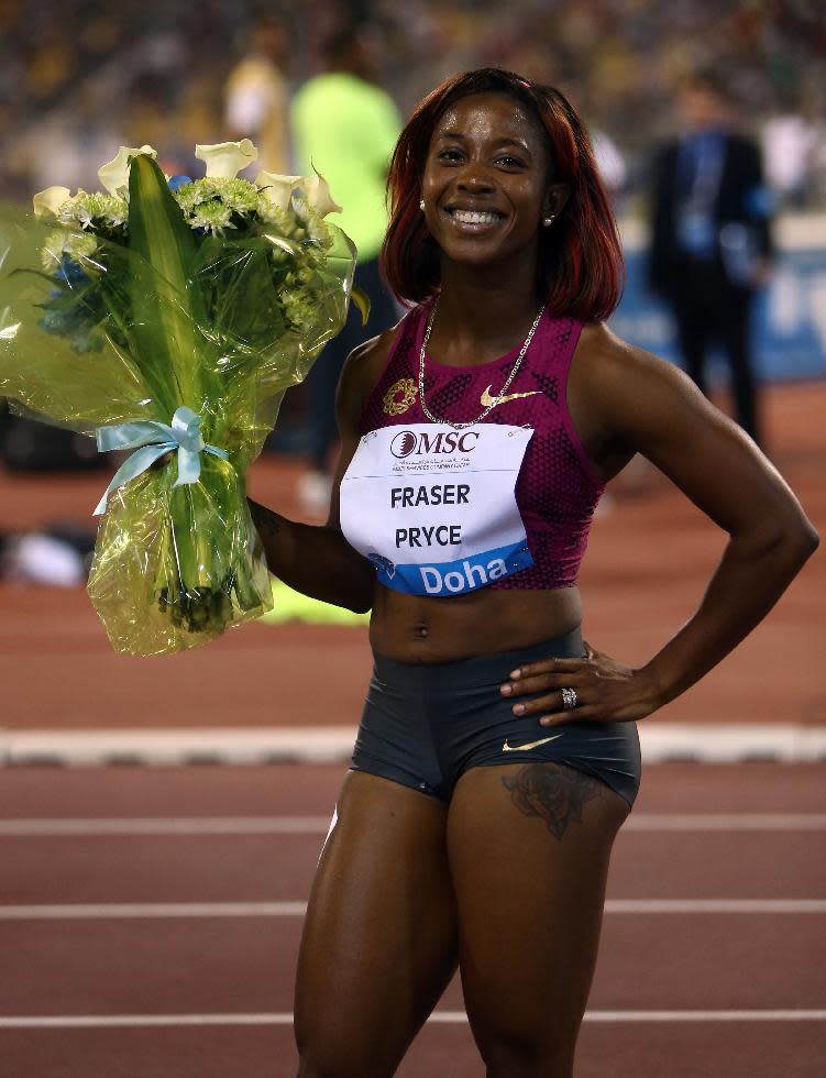 Shelly-Ann Fraser-Pryce of Jamaica wins the women's 100m at the IAAF Diamond League in the Qatari capital Doha, Friday May 9, 2014. (AP Photo/ Osama Faisal)