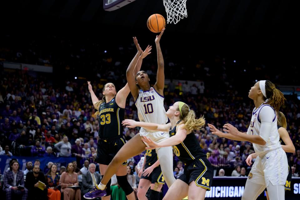 Angel Reese puts up a shot through traffic against Michigan.