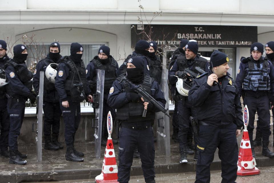 Riot police stand as dozens of demonstrators gathered in front of Turkey's parliament to protest proposed amendments to the country's constitution that would hand sweeping executive powers to President Recep Tayyip Erdogan's largely ceremonial presidency, in Ankara, Turkey, Monday. Jan. 9, 2017. Parliament is kicking off a debate Monday on a set of draft amendments.(AP Photo/Burhan Ozbilici)