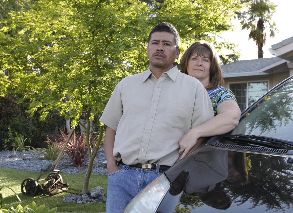 In this photo taken Monday, March 24, 2014, Martin Del Agua and his wife, Julie are seen at their home in Sacramento, Calif. Martin Del Agua faced deportation when he was arrested after a neighbor complained that he was playing music to loud in his garage.(AP Photo/Rich Pedroncelli)