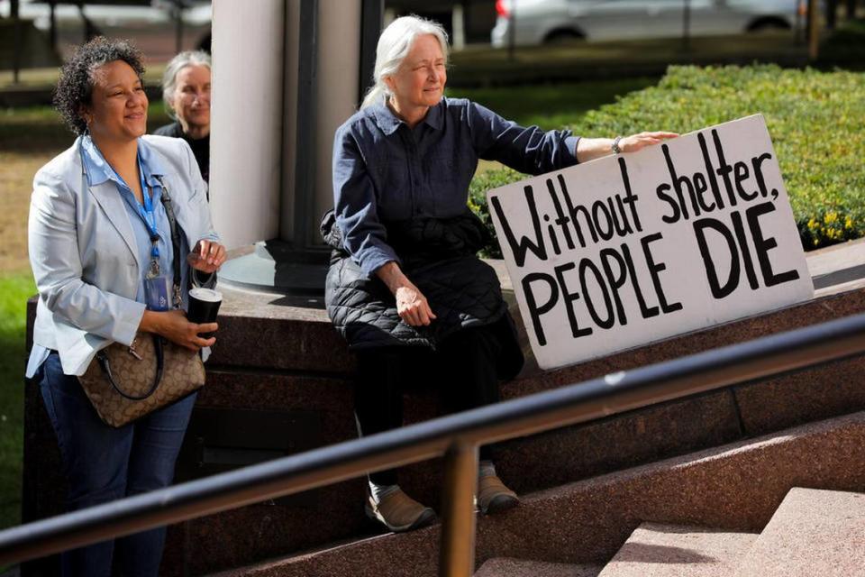 Protesters rally at the Nakamura Federal Courthouse on Monday as the U.S. Supreme Court heard oral arguments in Grants Pass v. Johnson, a case that would make it easier for cities to fine or jail people experiencing homelessness for sleeping in public.